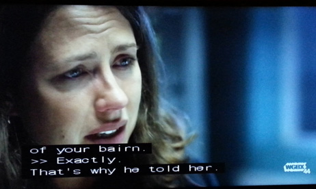 TV image with closed-captioning showing the word 'bairn'